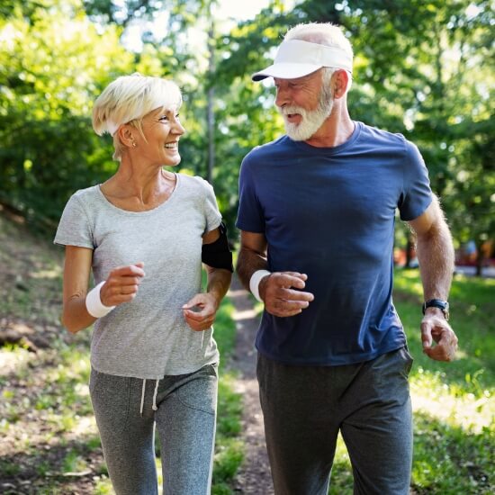 Two active adults running outdoors together